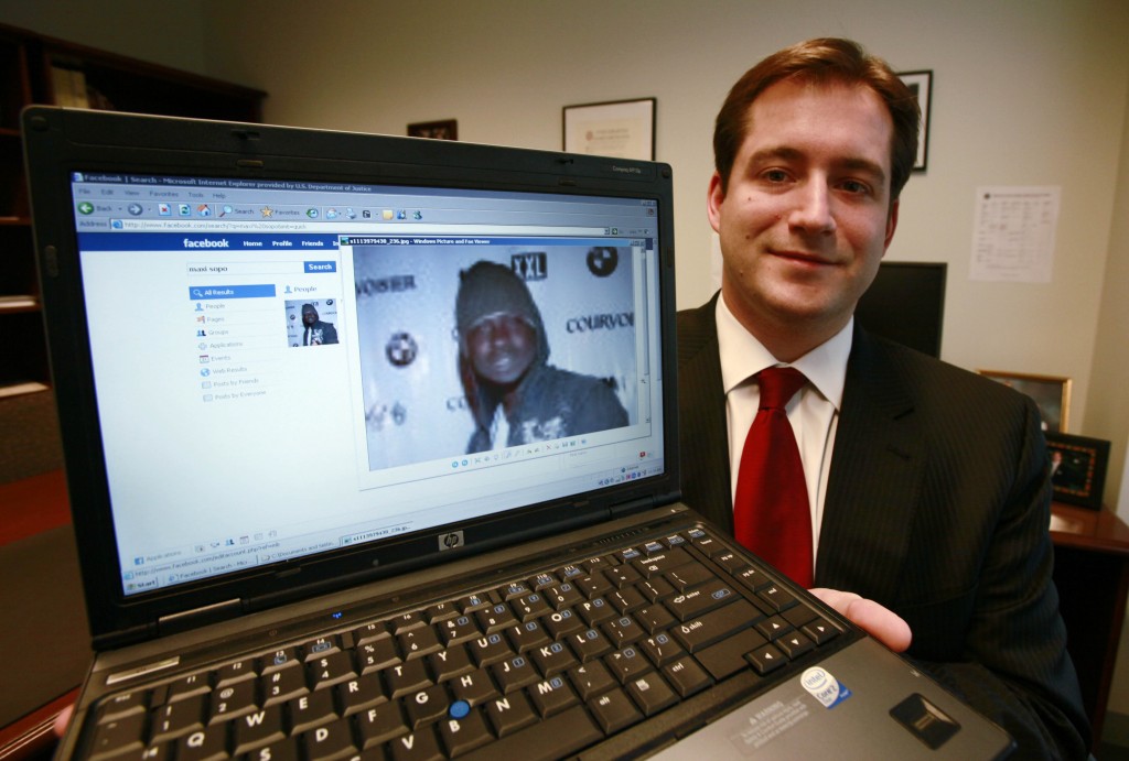 Assistant U.S. Attorney Michael Scoville displays part of the Facebook page, and an enlarged profile photo, of fugitive Maxi Sopo Tuesday, Oct. 13, 2009, in Seattle. Sopo is currently in a Mexico City jail awaiting extradition to the U.S. He was arrested while living as a fugitive in Mexico after he added a former Department of Justice official to his friend list on the social networking website Facebook.com. (AP Photo/Elaine Thompson)